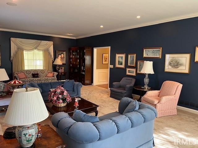 living room with crown molding and light colored carpet