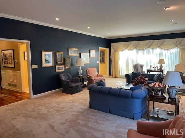 living room with ornamental molding and wood-type flooring