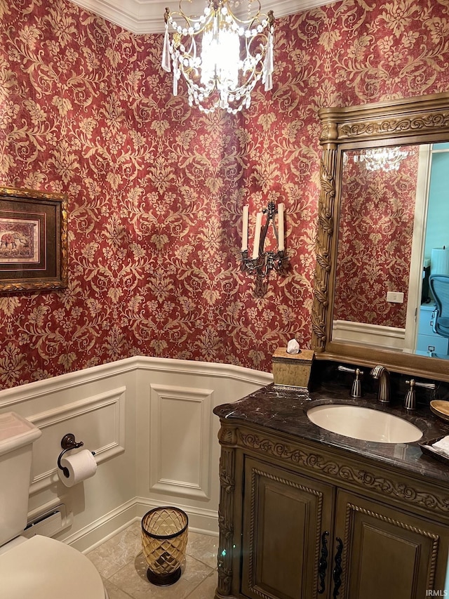 bathroom featuring vanity, toilet, tile patterned floors, and ornamental molding