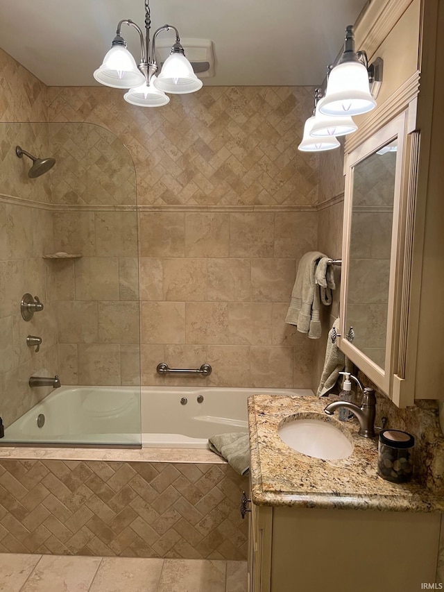 bathroom featuring vanity, tile patterned floors, a chandelier, and tiled shower / bath