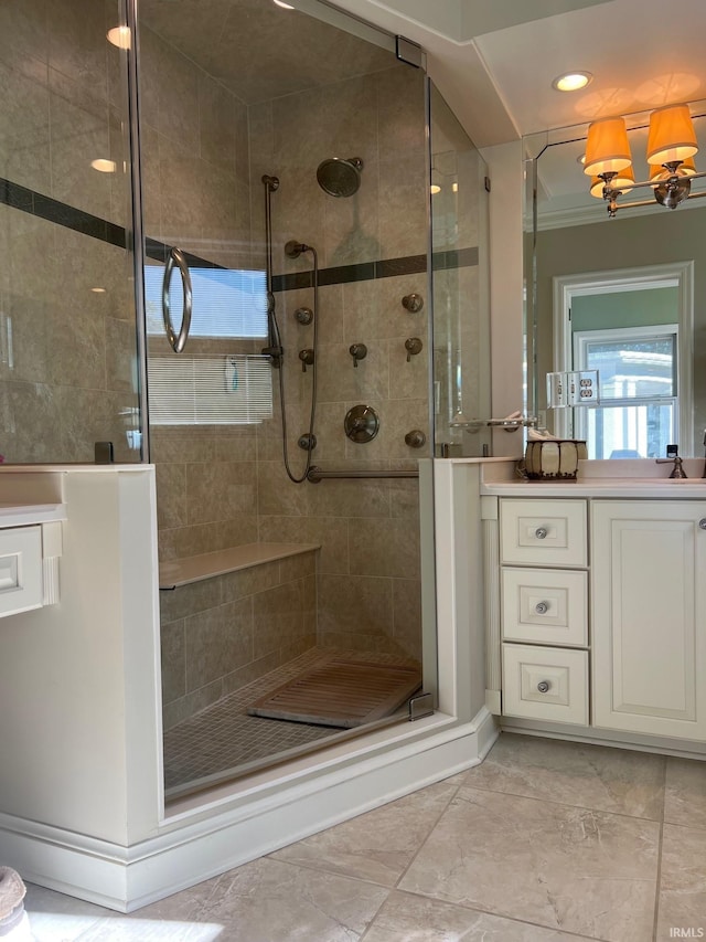 bathroom with vanity, a chandelier, and an enclosed shower