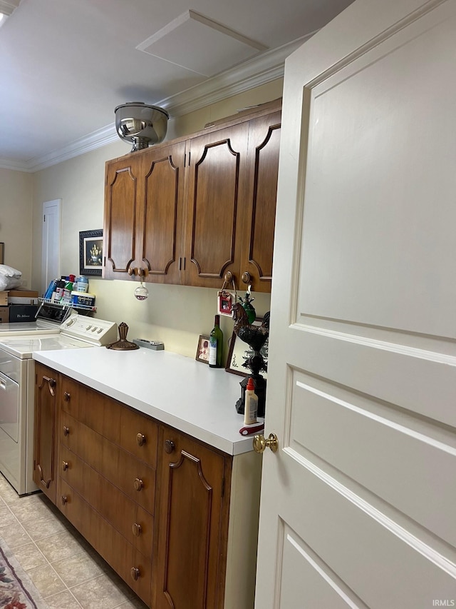 kitchen with ornamental molding, independent washer and dryer, and light tile patterned floors