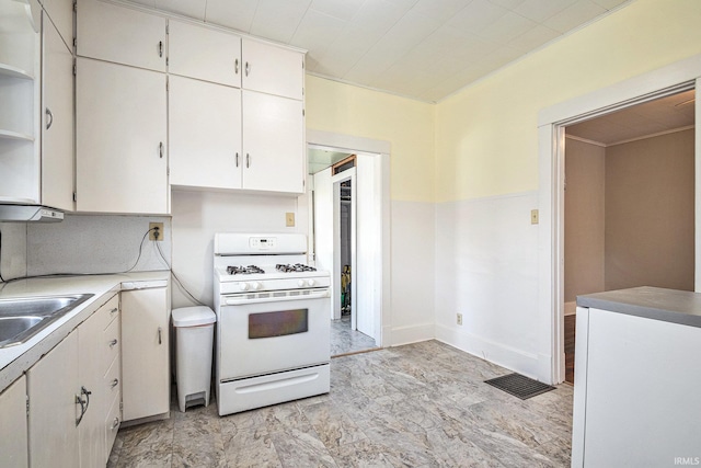 kitchen featuring white cabinetry, tasteful backsplash, sink, and white range with gas stovetop