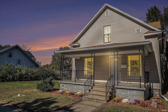 view of front facade featuring a yard and covered porch