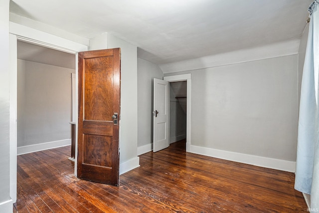 unfurnished bedroom with dark hardwood / wood-style flooring