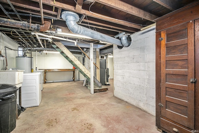 basement with water heater and independent washer and dryer