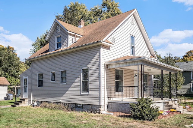 view of home's exterior featuring a yard and covered porch