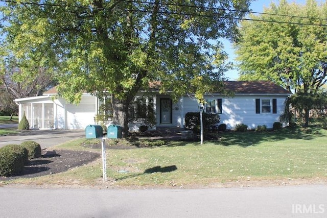 obstructed view of property featuring a front lawn and a garage