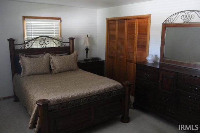 bedroom featuring a closet and light carpet