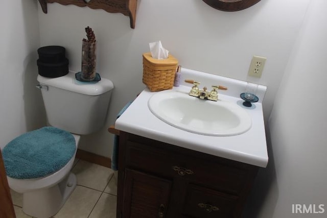 bathroom with vanity, toilet, and tile patterned floors