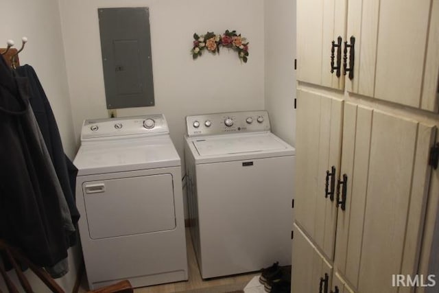 laundry area with cabinets, electric panel, and washer and clothes dryer