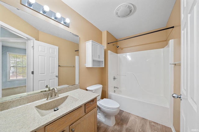 full bathroom with vanity, toilet, hardwood / wood-style flooring, and shower / bathing tub combination