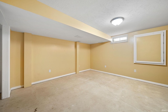 basement featuring a textured ceiling