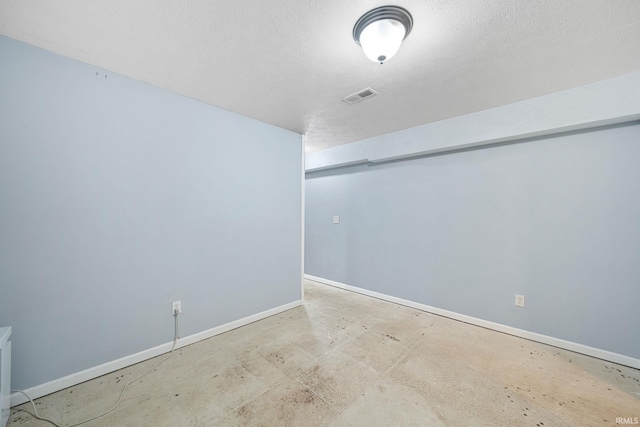 spare room with a textured ceiling