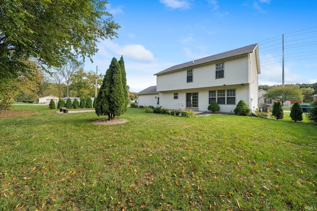 rear view of property with a patio area and a lawn