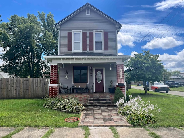 view of property featuring a front lawn and covered porch