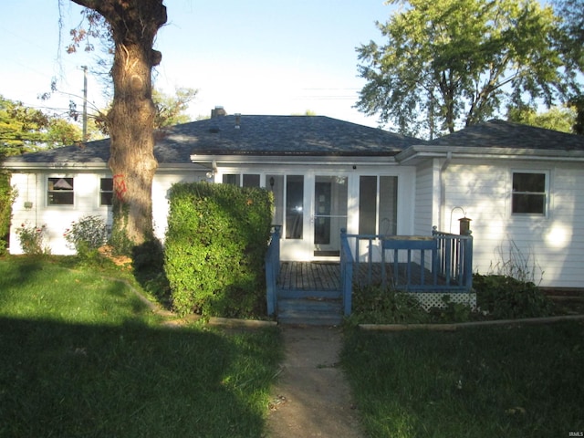 single story home featuring a deck and a front yard