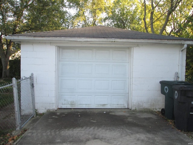 detached garage with fence and driveway