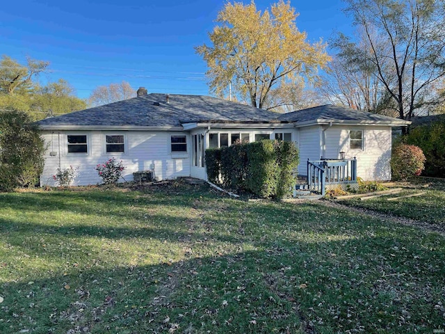 rear view of house with a yard