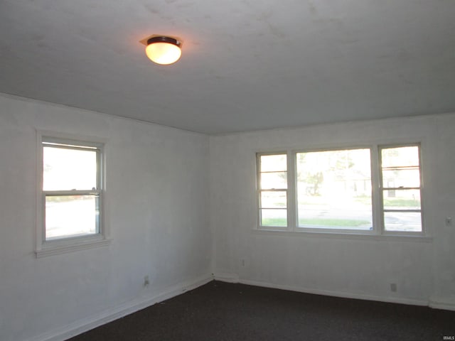 unfurnished room featuring baseboards