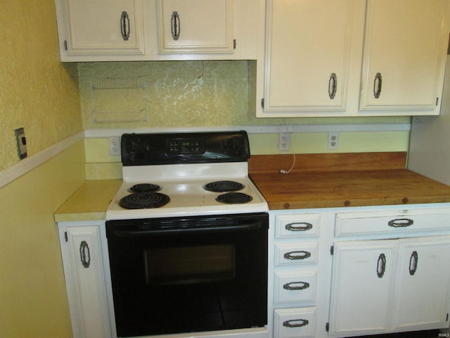 kitchen with white electric range oven, white cabinets, and decorative backsplash