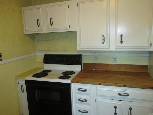 kitchen featuring white cabinets, white electric stove, and wood counters