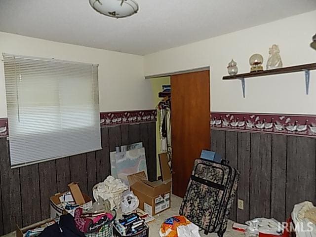 miscellaneous room featuring wood walls