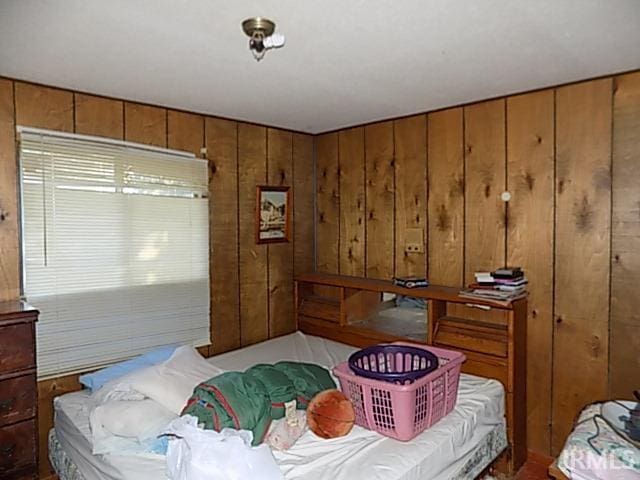 bedroom with wood walls