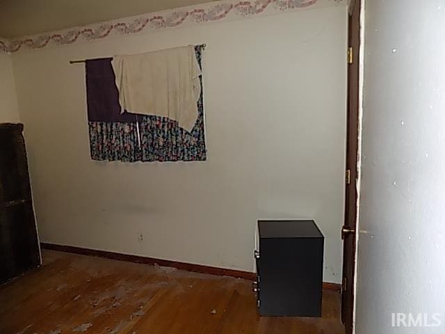 empty room with dark hardwood / wood-style flooring