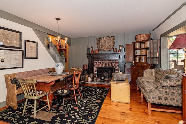 dining space with a fireplace and wood-type flooring