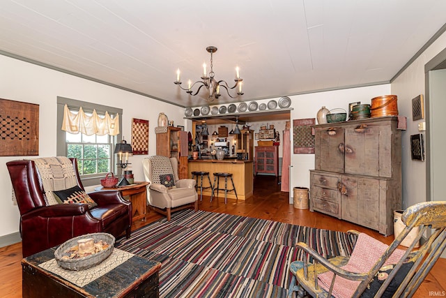 living room with dark hardwood / wood-style flooring and an inviting chandelier