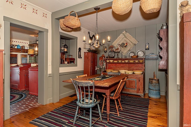 dining room featuring hardwood / wood-style floors and a chandelier