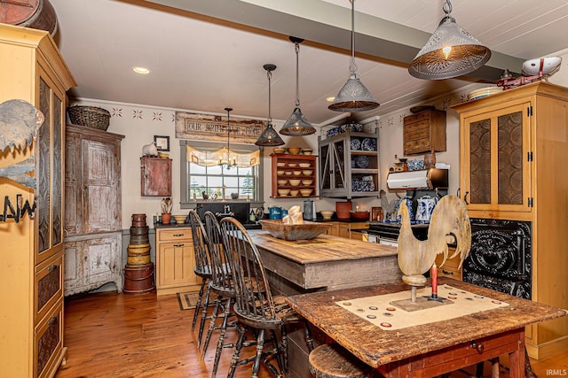 kitchen featuring a kitchen island, crown molding, wood-type flooring, and a chandelier