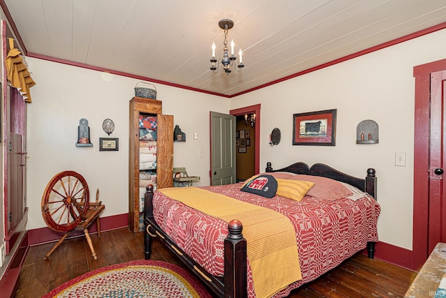 bedroom with ornamental molding, a chandelier, and dark wood-type flooring