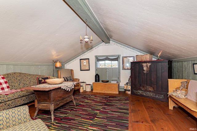 living room with wood walls, hardwood / wood-style floors, and lofted ceiling with beams