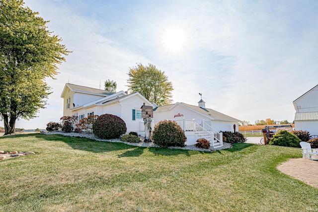 view of side of property with a lawn