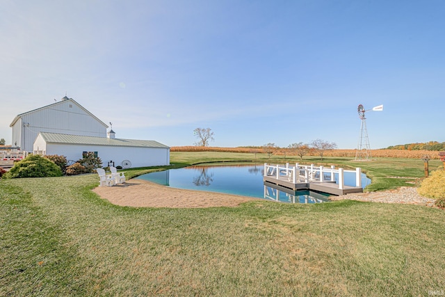 dock area with a water view and a lawn