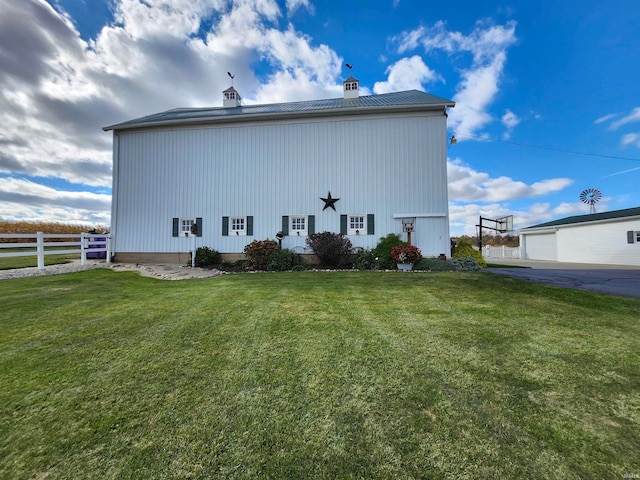 view of side of home with a lawn