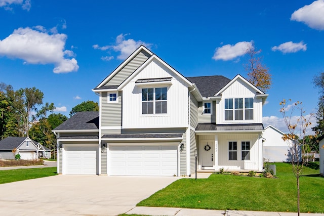 view of front of property featuring a front lawn and a garage