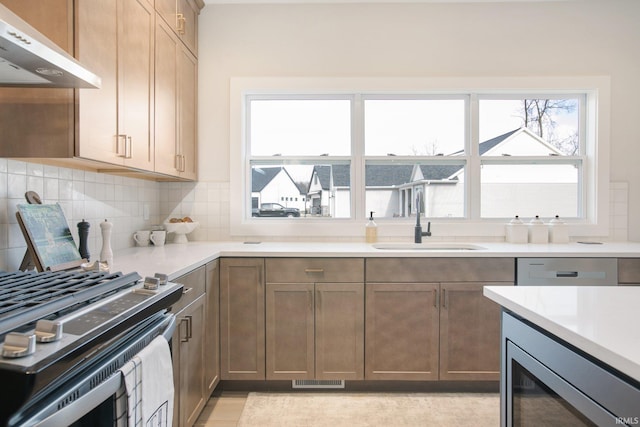 kitchen featuring sink, backsplash, stainless steel appliances, range hood, and wine cooler