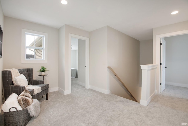 living area featuring light carpet