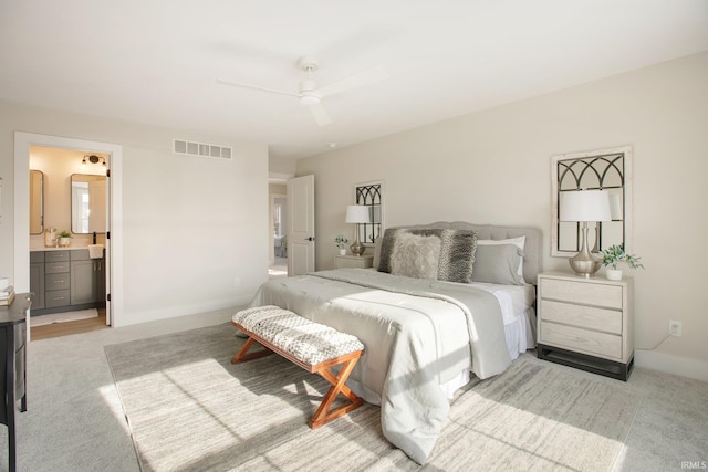 carpeted bedroom featuring ensuite bathroom and ceiling fan