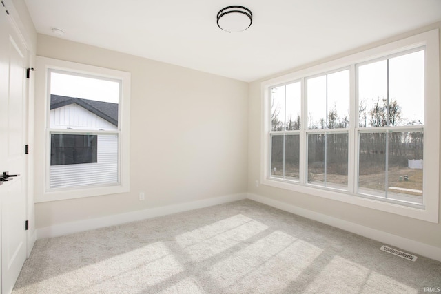 unfurnished room with vaulted ceiling and light colored carpet