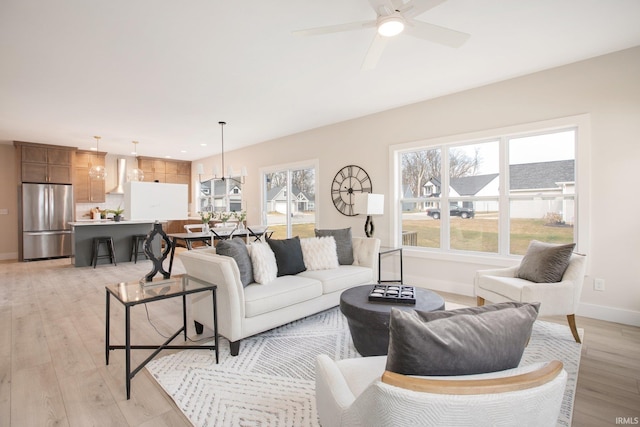 living room with light hardwood / wood-style flooring and ceiling fan