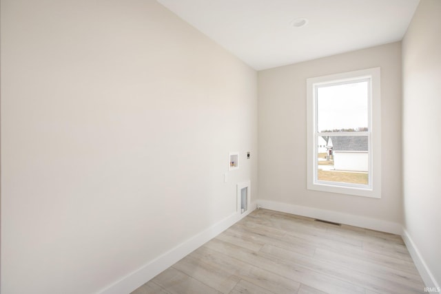 laundry area with hookup for a washing machine, light hardwood / wood-style flooring, and hookup for an electric dryer