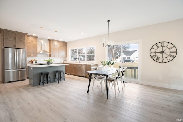 dining room with an inviting chandelier and light hardwood / wood-style flooring