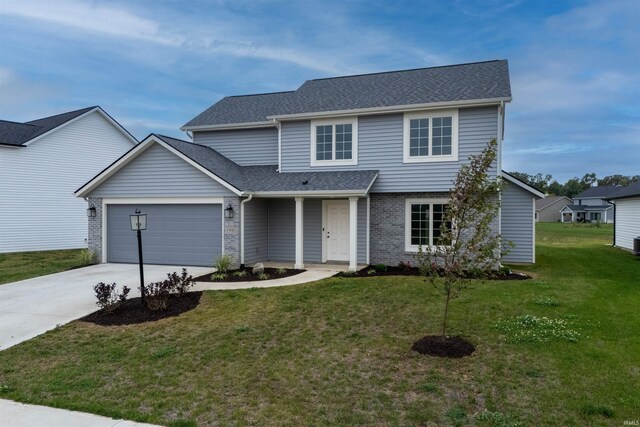 front facade with a front yard and a garage