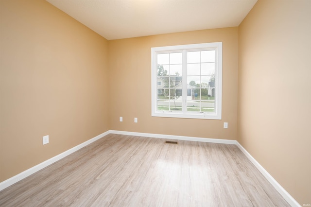 empty room with light hardwood / wood-style floors