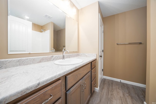 bathroom with vanity and hardwood / wood-style flooring