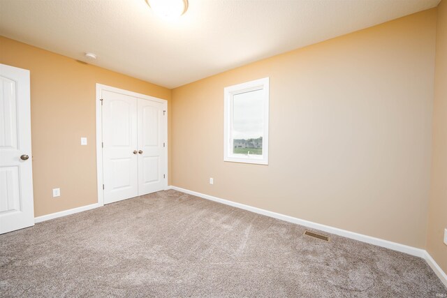 unfurnished bedroom featuring a closet and carpet